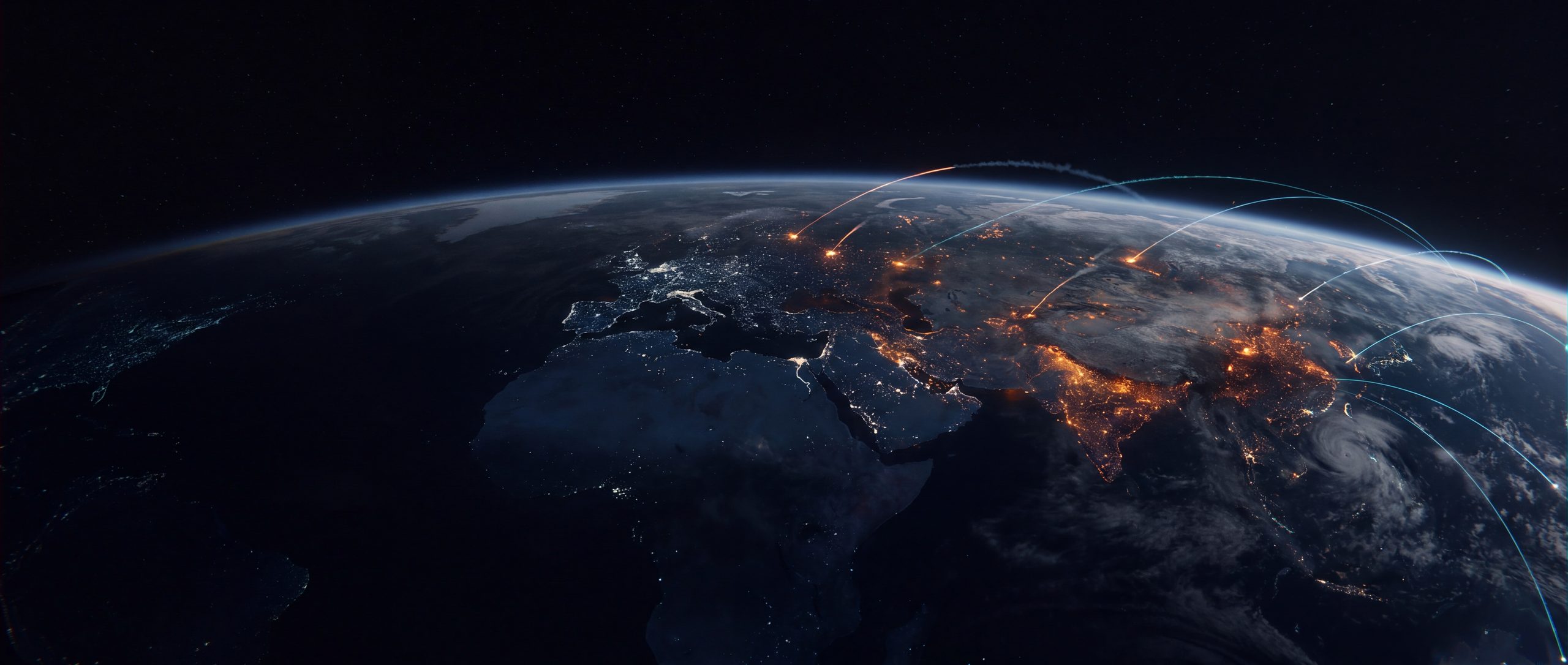 An illustration of the Eastern Hemisphere from orbit at night, amber light glowing through cloud in several separate regions and cold arcs of light crossing the Pacific.